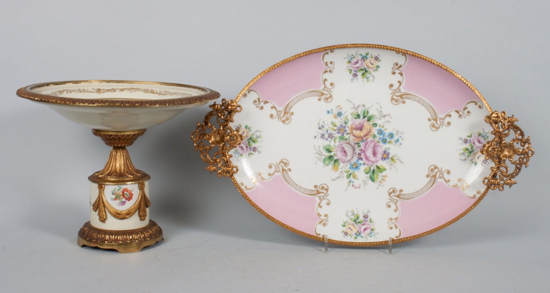 French porcelain compote & serving dish: 20th century; gilt-metal-mounted porcelain compote, with pseudo Sevres marks and image of young lovers in garden, 7 in. H., 10 in. Diam., and Limoges porcelain platter set in footed and handled gilt-m