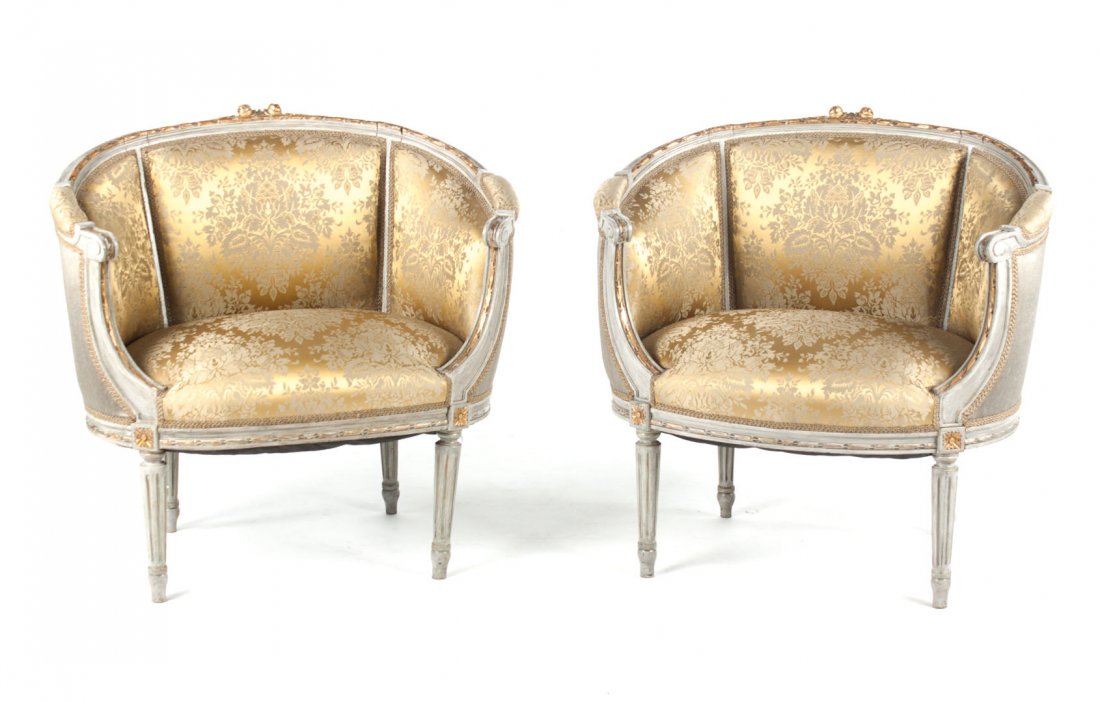 Pair Louis XVI style bergeres: 20th century; painted and giltwood frames with floral upholstery, and four reeded legs, 32 in. H., 33 in. W.