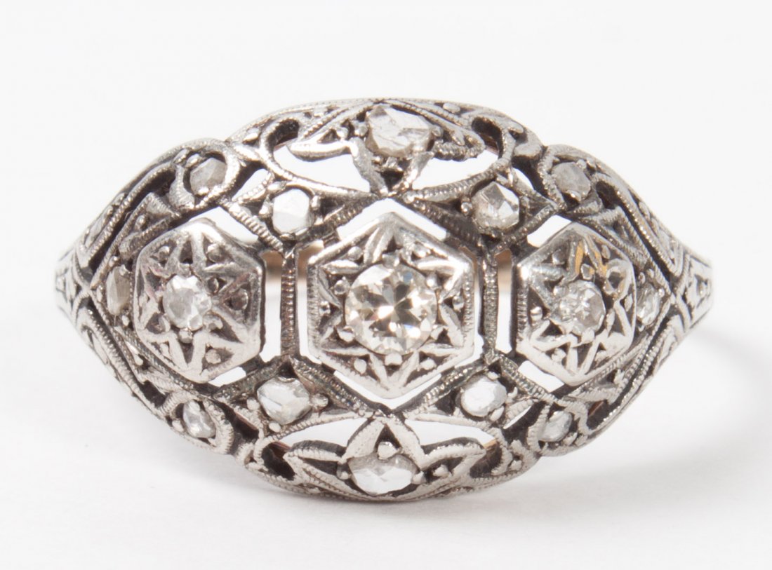 Edwardian diamond and white gold dome ring: with small round mine-cuts and rose-cut stones, unmarked white gold, size 10; 2.8 grams