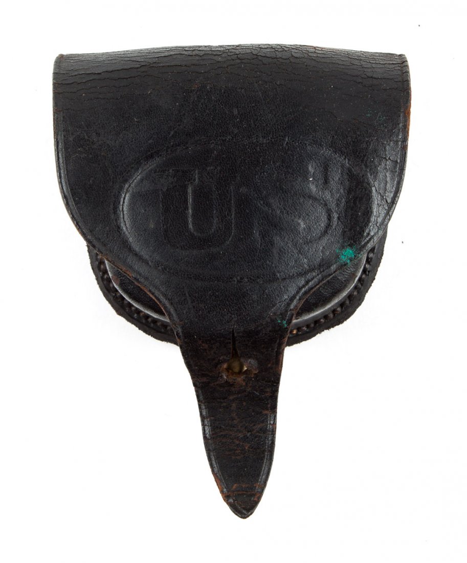 Accoutrement: leather cap box: black leather case, "US" in oval embossed on the flap, apparently made without inner flap, sheepskin liner (no wool left); 3 1/2 X 3 1/2 X 1 1/2 in.