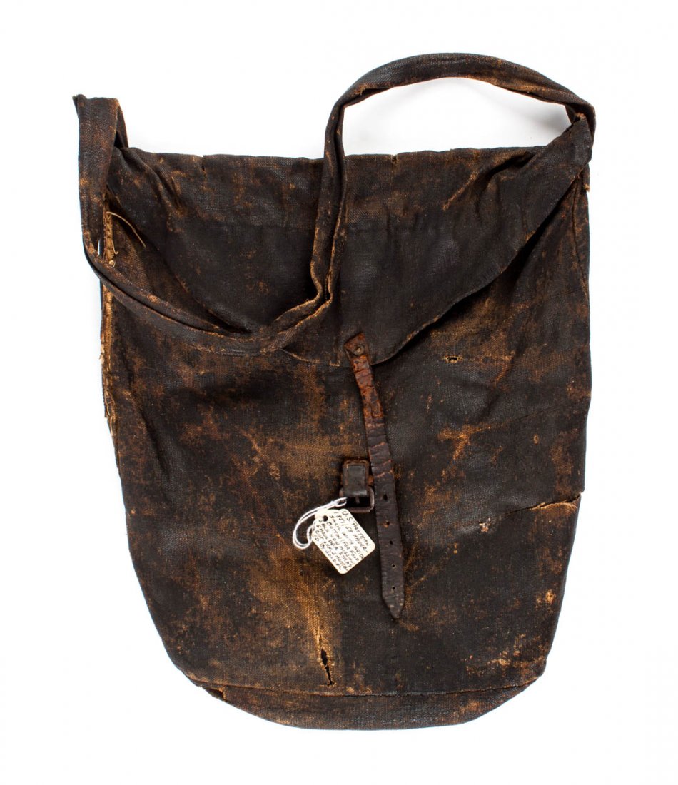 Accoutrement: Confederate haversack: U.S. Model 1851 canvas bag, painted black and sealed with linseed oil, the flap secured with leather strap and iron buckle, 14 1/4 X 12 1/2 in.; inner bag with one remaining bone button; the shoulder 