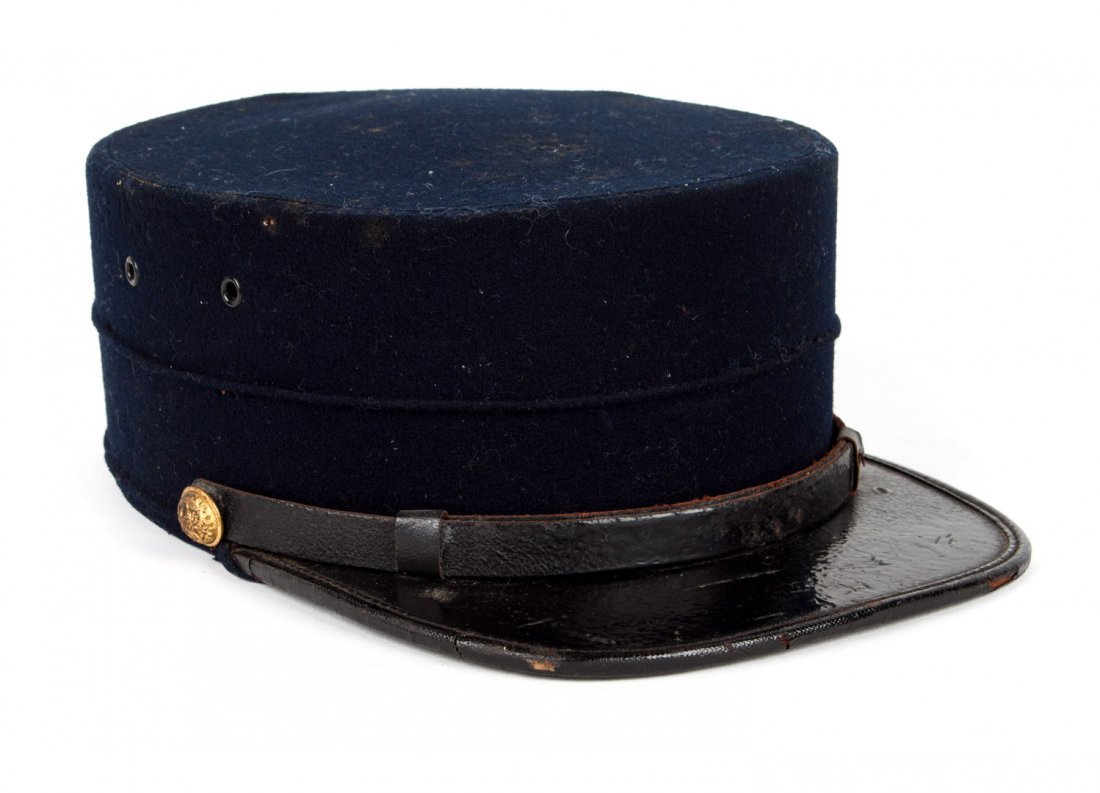 United States Army cap: with label of Kuenzel Brothers, Philadelphia, late 19th century: blue wool forage cap with eagle chin strap buttons and 4 vent; 10 in. L., 6 3/4 in. W.