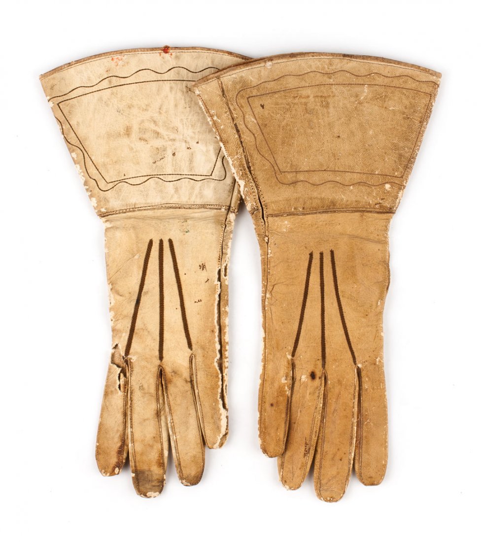 Accoutrements: Pair of gauntlets: tan kidskin with decorative brown stitching, both stamped "8 1/2" inside; 13 X 7 1/2 in.