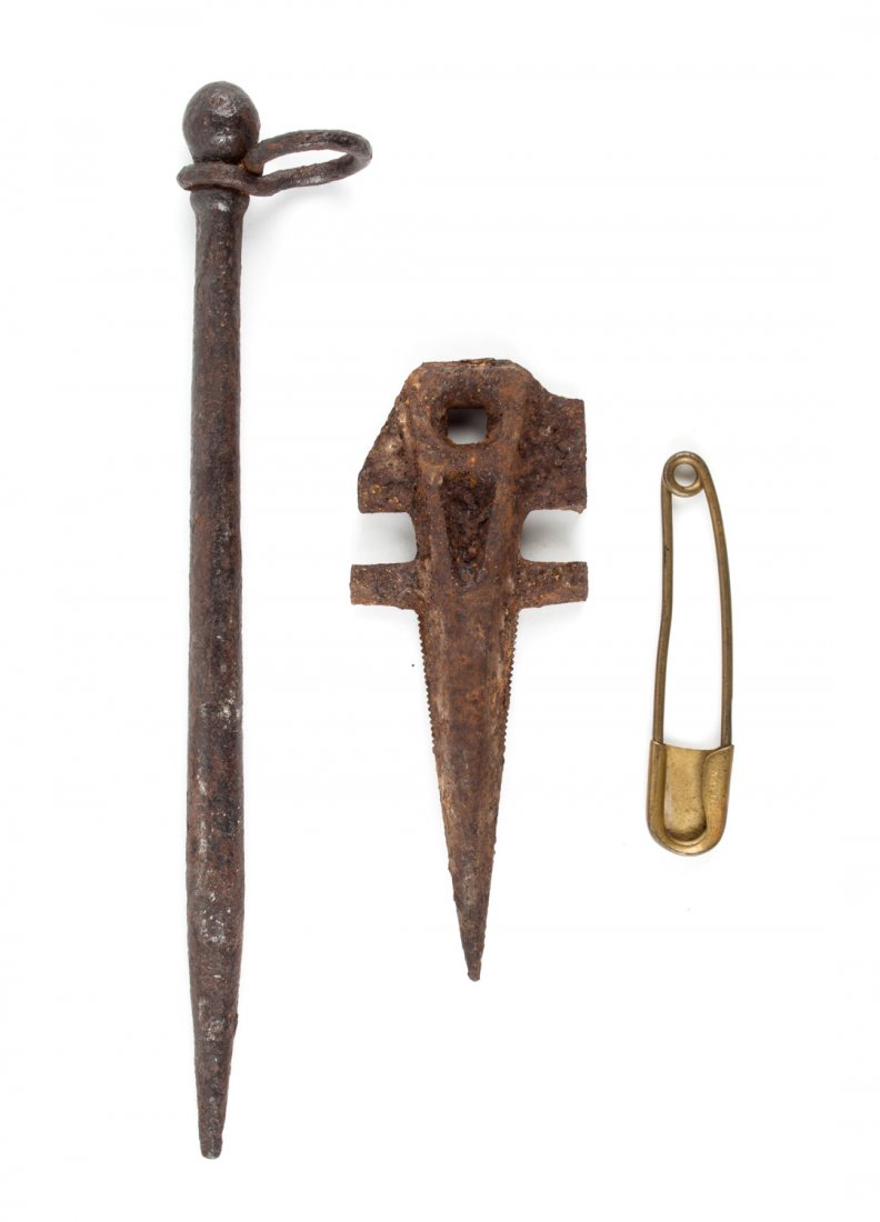 Cavalry accessories: Three pins or stakes: comprising: a brass pin stamped "National," 5 1/8 in. L.; a wrought iron ring and stake for picketing horses, 13 1/2 in. L.; and a heavy cast-iron stake, 7 3/4 in. L.
