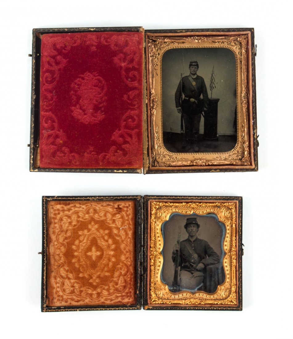 Photographs: Portraits of two Union infantrymen: each in full uniform, holding rifle, comprising: one seated, ambrotype, 3 1/4 X 2 3/4 in., shaped mat, stamped leather case; the other standing, tintype, 4 1/4 X 3 1/4 in., stamped leather case