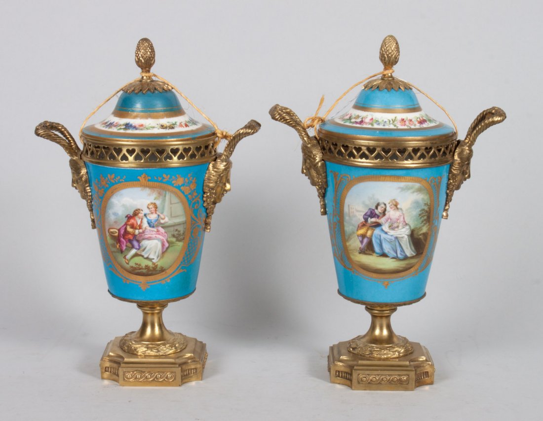 Pair of French porcelain cachepot urns: gilt-metal-mounted, blue celeste ground with vignettes of lovers in garden and flowers, with pseudo Sevres mark, 12 in. H.