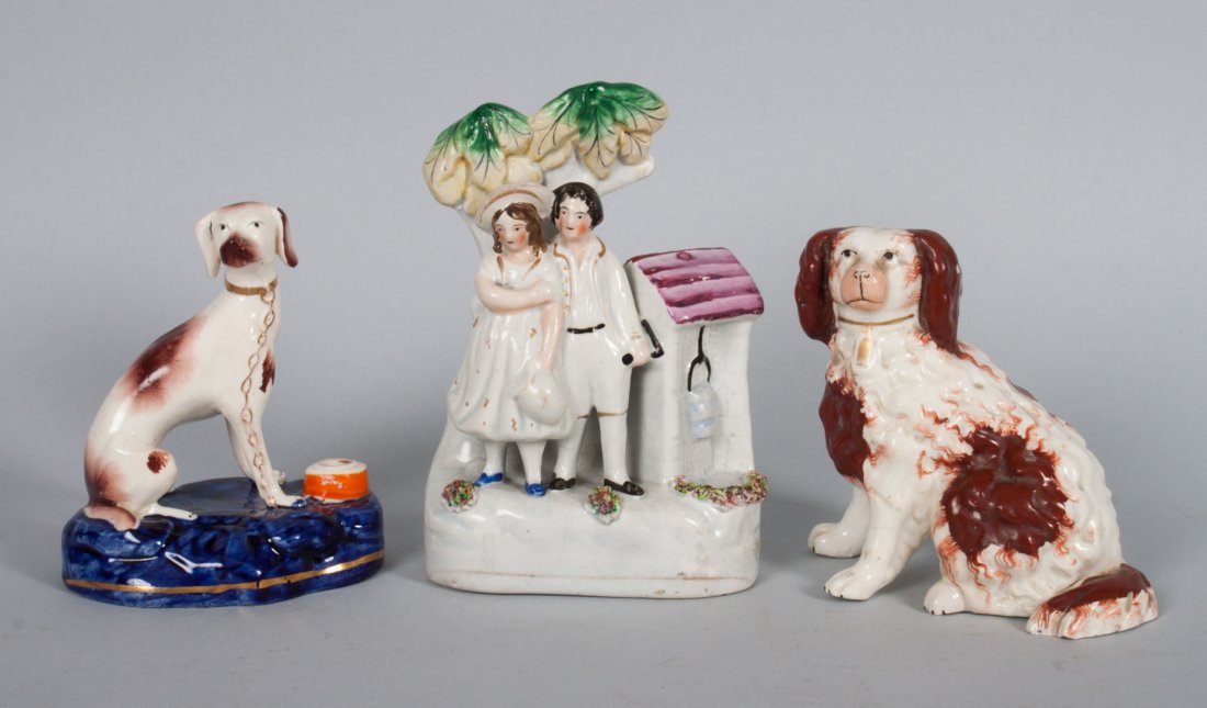 Three Staffordshire earthenware figures: two children and a well, Cavalier King Charles spaniel, dog on a pillow inkwell, 4 to 6 in. H.