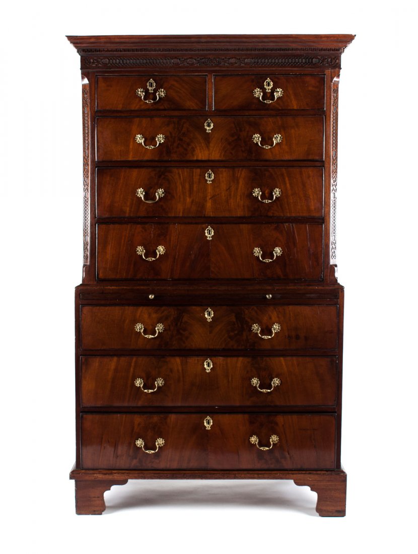 George III carved mahogany chest-on-chest: late 18th century; flat blind fretted and dentil carved cornice, two short and three long drawers in top section with blind fret pilaster supports, base with brushing slide and three long drawers, str
