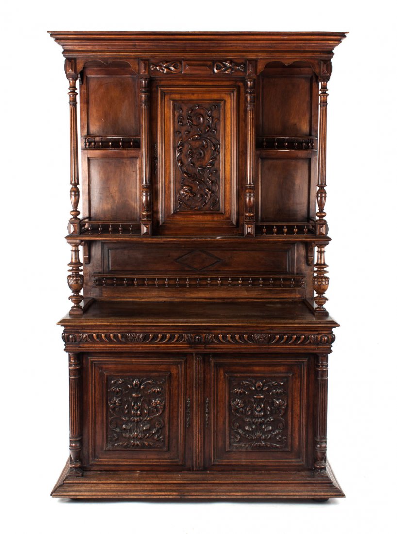 Belgian carved walnut buffet Ã deux corps: second half-19th century; elaborately carved upper case with floral and foliate relief decoration, reeded supports, and balustrade display areas; bottom case with two drawers and foliate and floral re