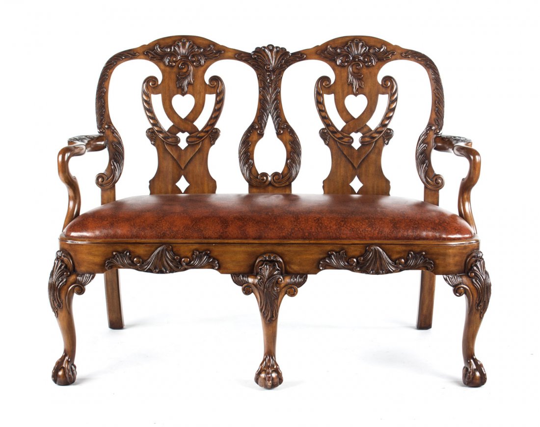 Chippendale style carved upholstered settee: Serpentine crest rail, double chair back splats, shepherd's crook arms, naugahyde upholstered slip seat, cabriole legs, ball and claw feet. 39 in. H., 51 in. W., 22 in. D