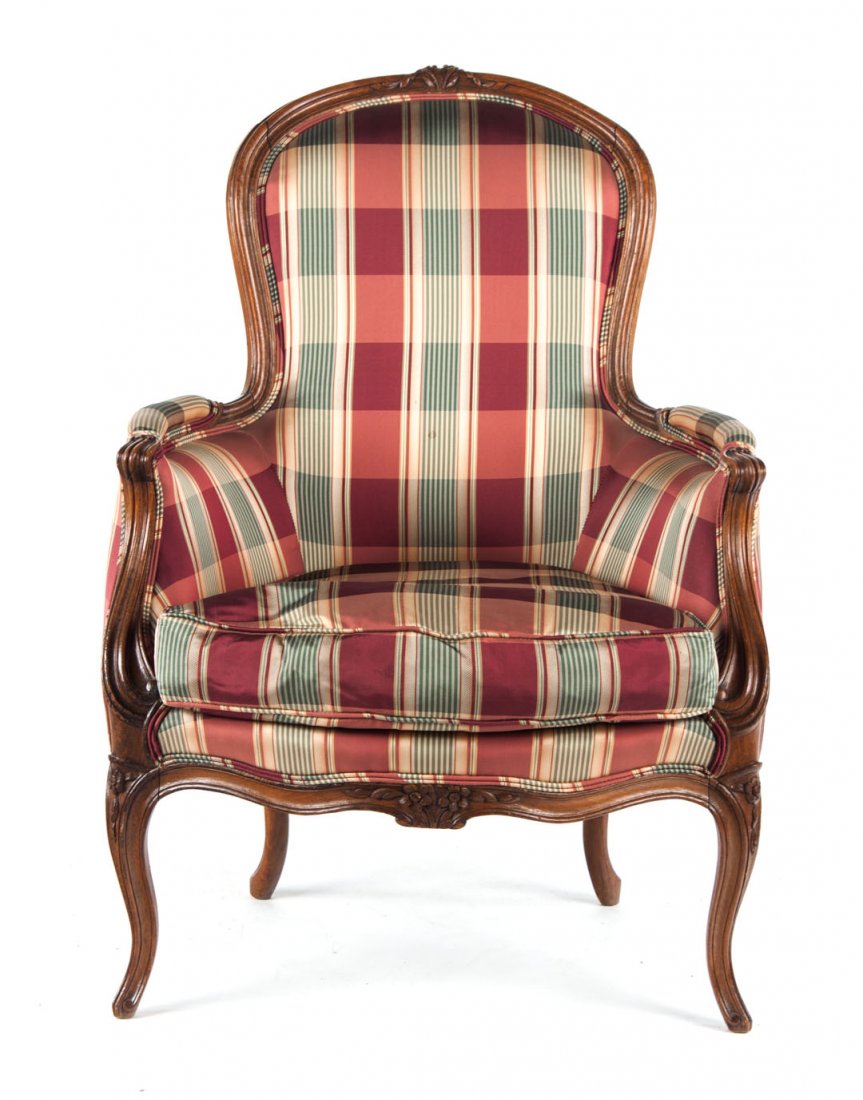 Louis XV style beechwood upholstered bergere: carved, exposed frame; upholstered panel back, armrest and seat cushion, cabriole legs, 37 in. H., 26 in. W., 23 in. D