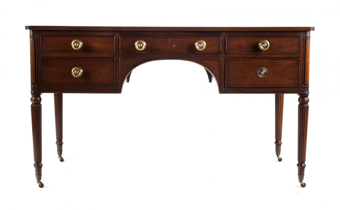 Kittinger Federal style mahogany kneehole desk: inset tooled leather top, single drawer flanked by two stacked short drawers, reeded legs ending in casters, 31 in. H., 54 in. W., 30 in. D.