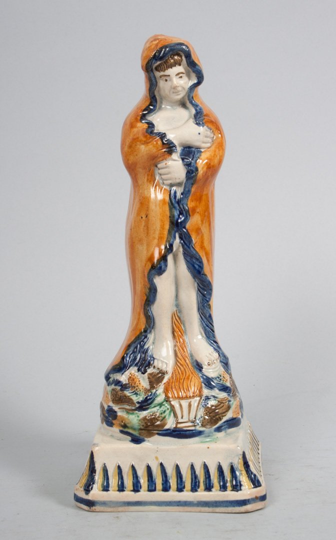 Staffordshire pearlware figure of "Winter": circa 1800; probably Enoch Wood, modeled as shivering cloaked figure standing next to fire, 9 1/4 in. H.