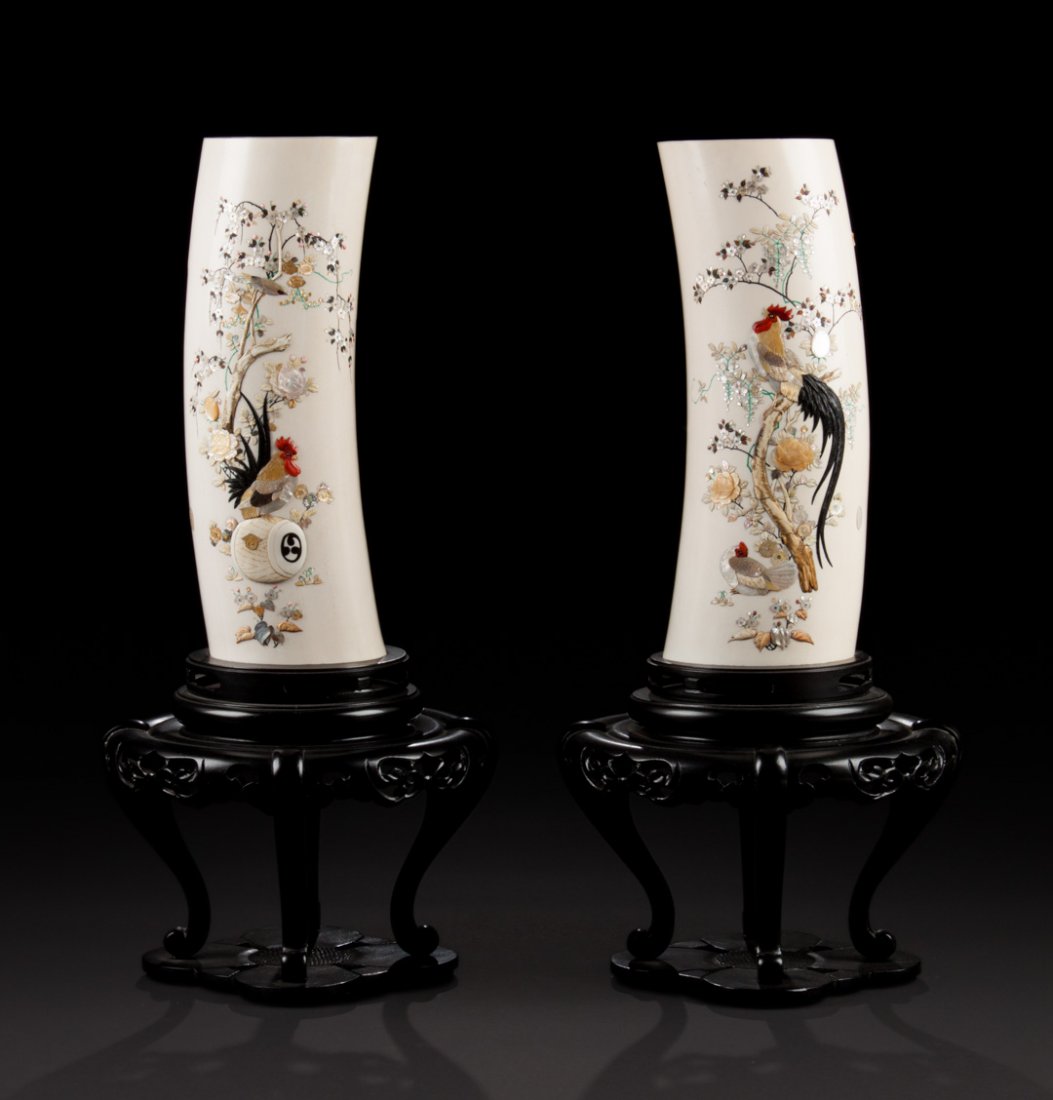 Pair of Japanese Shibayama carved ivory tusks: with elaborate mother-of-pearl and hardstone relief inlays depicting roosters and chickens, mounted on ebonized wood stands, 24 in. H. total; tusks - 15 in. H.