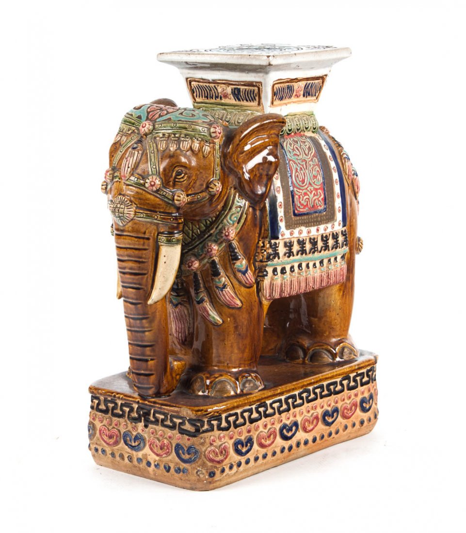 Chinese Export elephant garden stool: glazed terracotta modeled as elephant in parade garb with seat on back, 23 in. H., 18 in. W.
