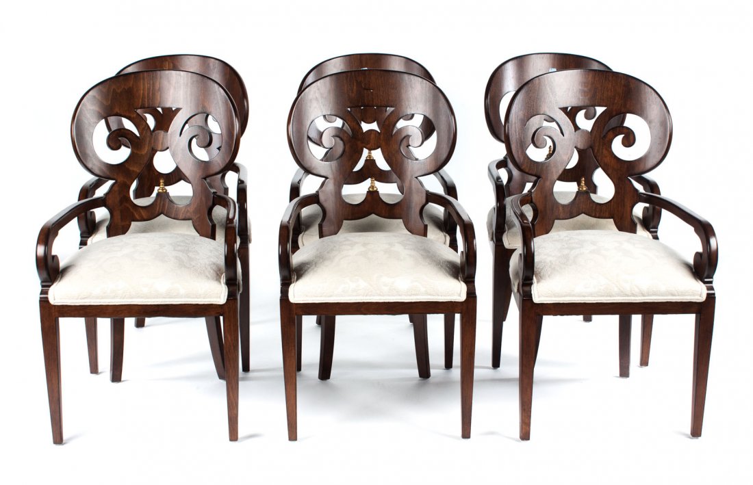 Set of six Biedermeier style armchairs: curved openworked scroll carved backs with gilt finials; open arms, upholstered seats over half frame. 40 in. H., 22 in. W.