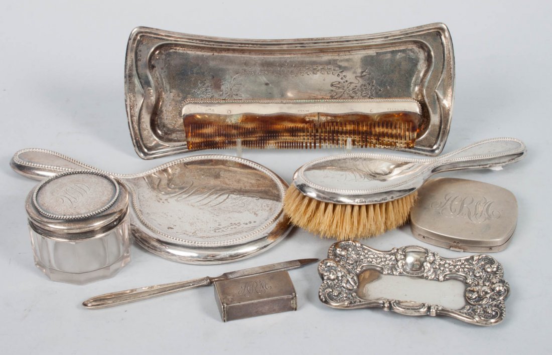 Nine sterling silver personal & dresser items: including: dresser tray, pin tray, hair brush & comb, hand held mirror, nail file, pill box, powder jar and a powder compact; 5.75 ozt. of weighable silver