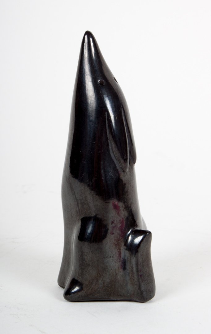 Santa Clara blackware coyote effigy: modeled as stylized howling coyote, signed "Jopovi L. Arkan, Santa Clara Pueblo," 4 in. H.