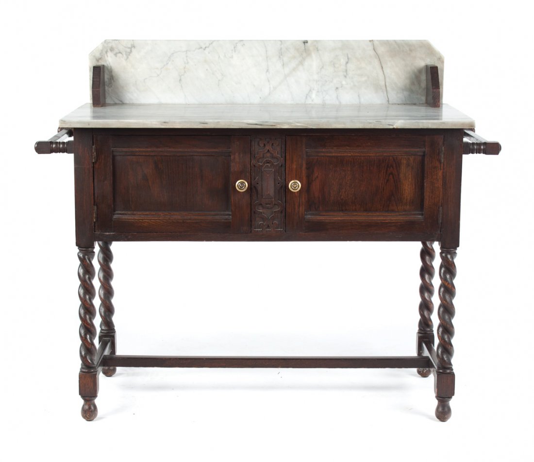 Elizabethean Revival oak marble top washstand: grey variegated marble top with 7 in. splash board, double side towel bars, two cabinet doors on barley twist legs, connected by stretchers, 37 in. H., 44 in. W., 18 1/2 in. D.