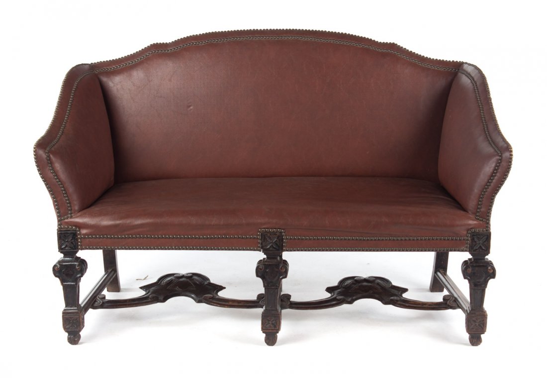 Louis XIV style carved oak upholstered settee: curved crest rail, slopping arms, studded faux leather upholstery over frame, carved legs, 33 1/2 in. H., 48 1/2 in. L., 24 in. D.