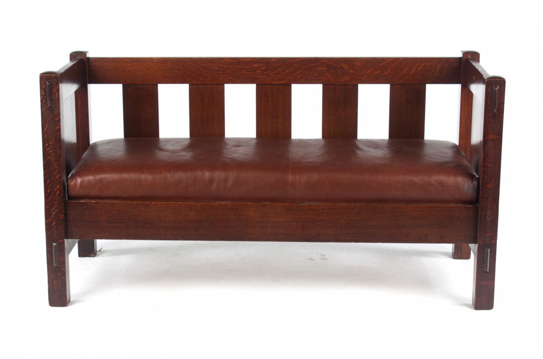 Gustav Stickley mission oak settee: first quarter-20th century; pierced back and side splat with mark on lower back leg, slip leather upholstered seat, 29 in. H., 56 in. W., 22 in. D.