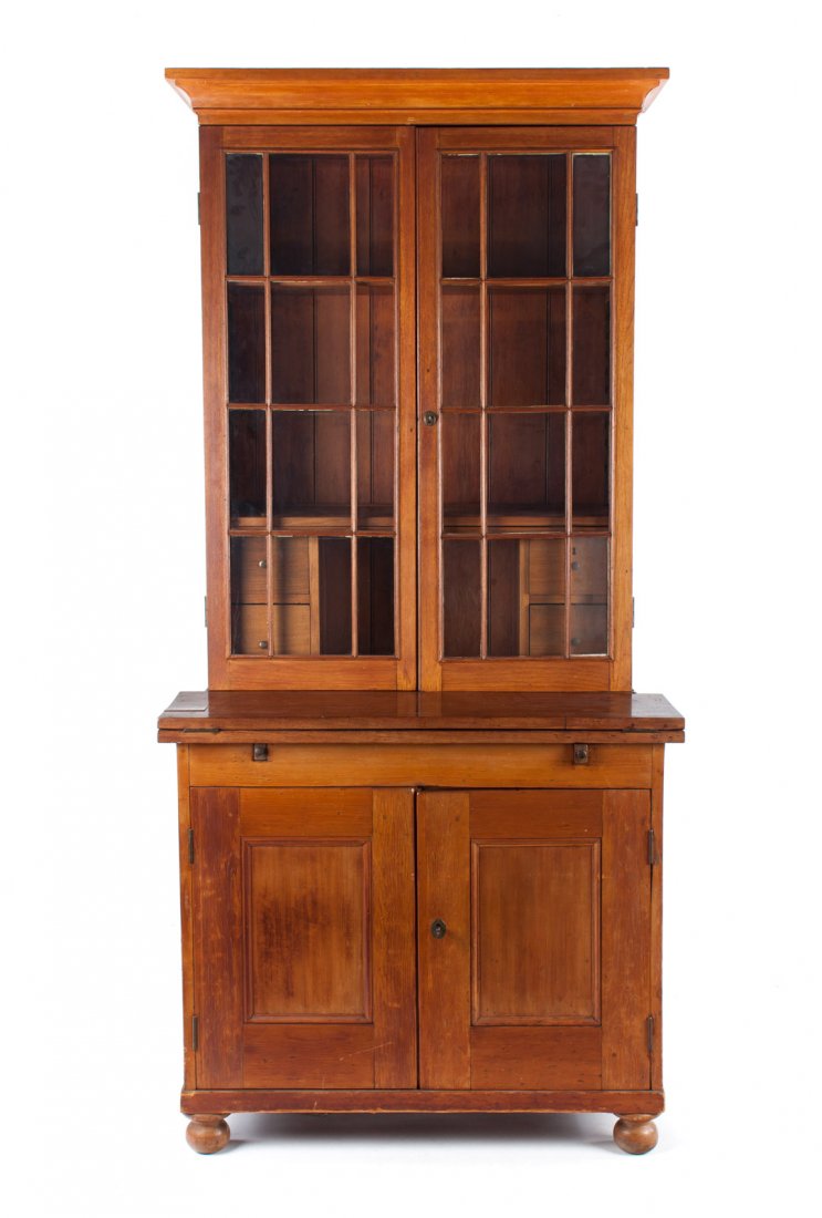 American vernacular walnut & pine bookcase: flat molded cornice, compartment with shelves enclosed by double glass panel doors, hinged writing board, and panel door lower section, 82 in. H., 38 1/2 in. W., 25 1/4 in. D.