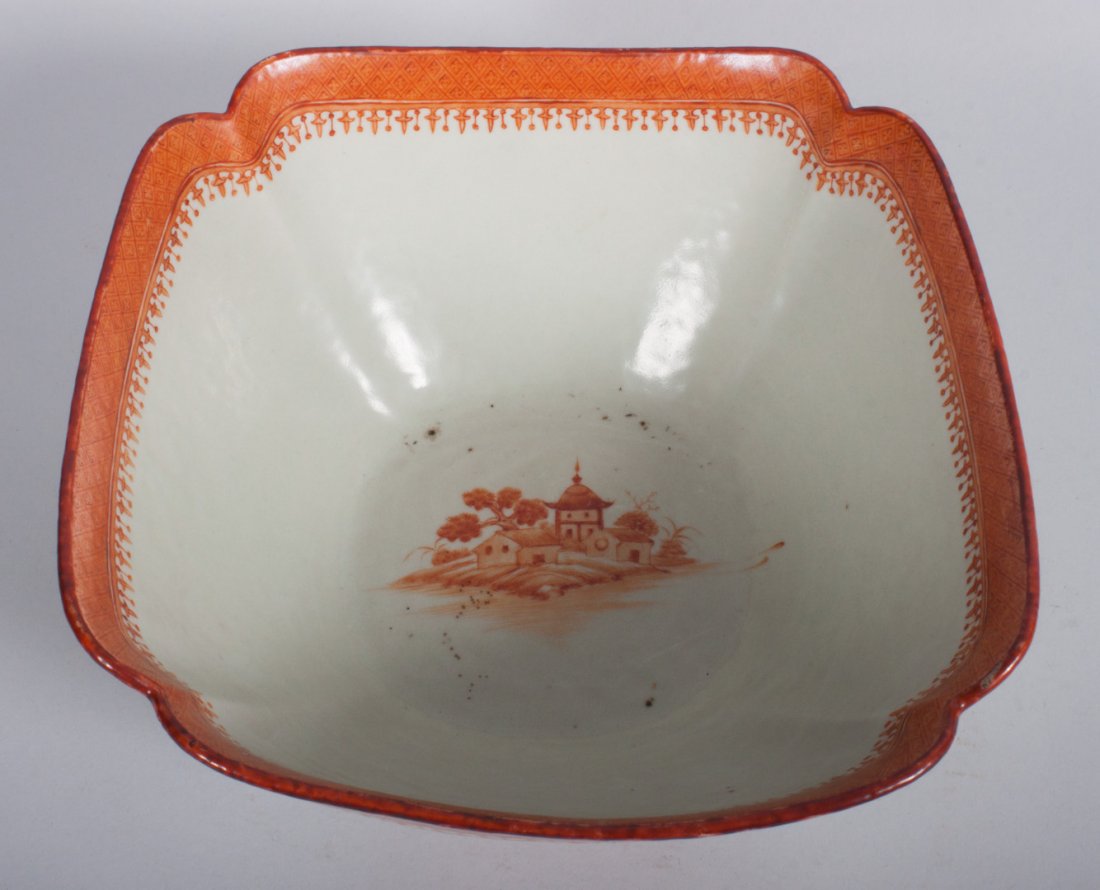 Chinese Export orange Nanking corner-cut bowl: fourth quarter-19th century; porcelain bowl with river scene and landscape vignettes, cross-hatch and spear head border, 4 in. H., 9 in. Sq.