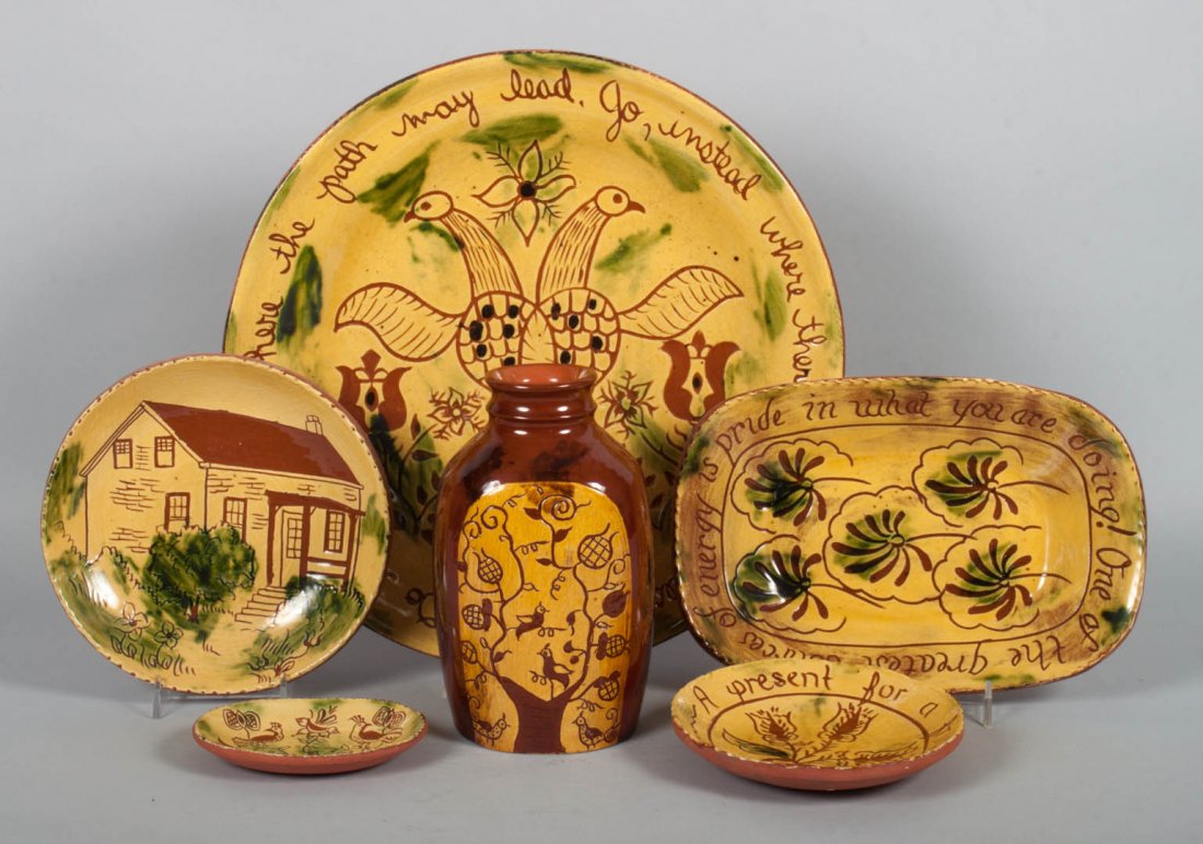 Assorted yellow slip-glazed redware items: circa 1980's; 17 sgraffito decorated pieces including: bowls, plates, and miniature dishes, some signed and dated