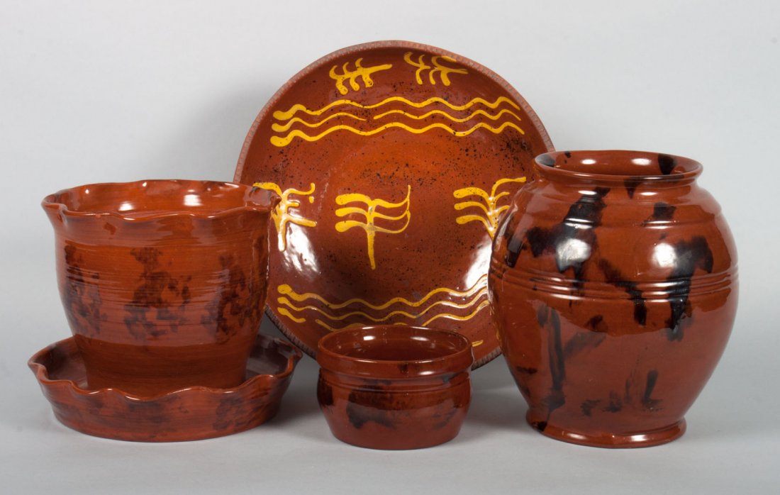 Assorted contemporary American redware pottery: some with yellow slip glaze decoration, 7 pieces, including: 3 jardinieres, bean pot, sugar bowl, and dish