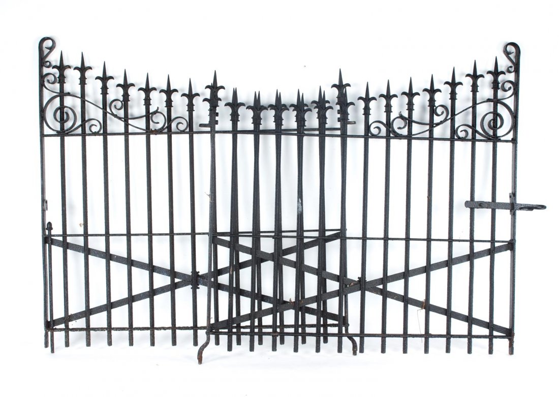Pair of late Victorian wrought iron gates: early 20th century; each with spear tip tops and scrolls, 58 in. H. 59 1/2 in. W.