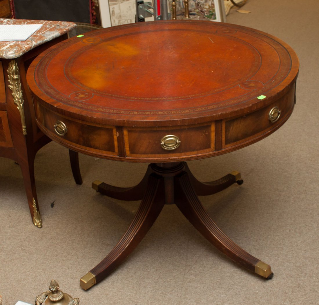 George III style mahogany drum table: 36 in. round tooled leather inset top, with drawers in apron, turned standard with three excurvate splayed legs, 29 1/2 in. H.
