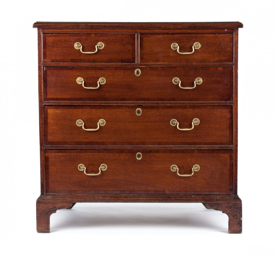 George III banded inlaid oak chest of drawers: late 18th/early 19th century; flat top with inlaid and molded edge, two short and three long drawers in case, straight bracket feet, rosette and bale brasses (replaced), 38 1/2 in. H., 37 1/2 in. W., 