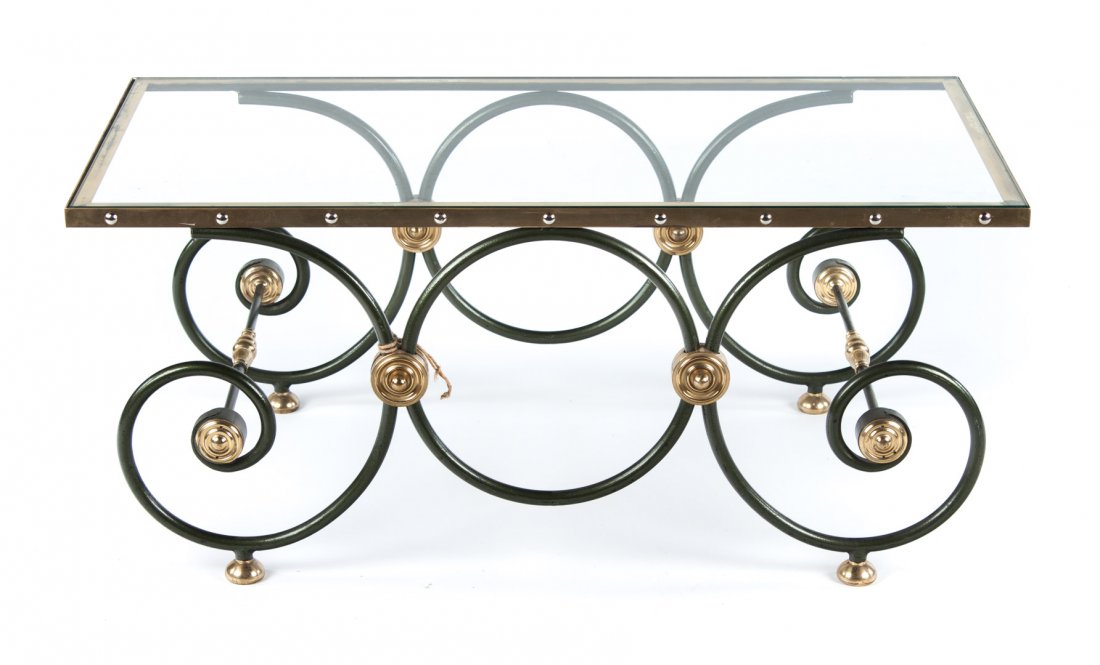 Contemporary coffee table: wrought verde antiqua iron, brass, and glass coffee table with scrolled base and brass rosettes, 18 in. H., 42 in. W., 21 3/4 in. D.