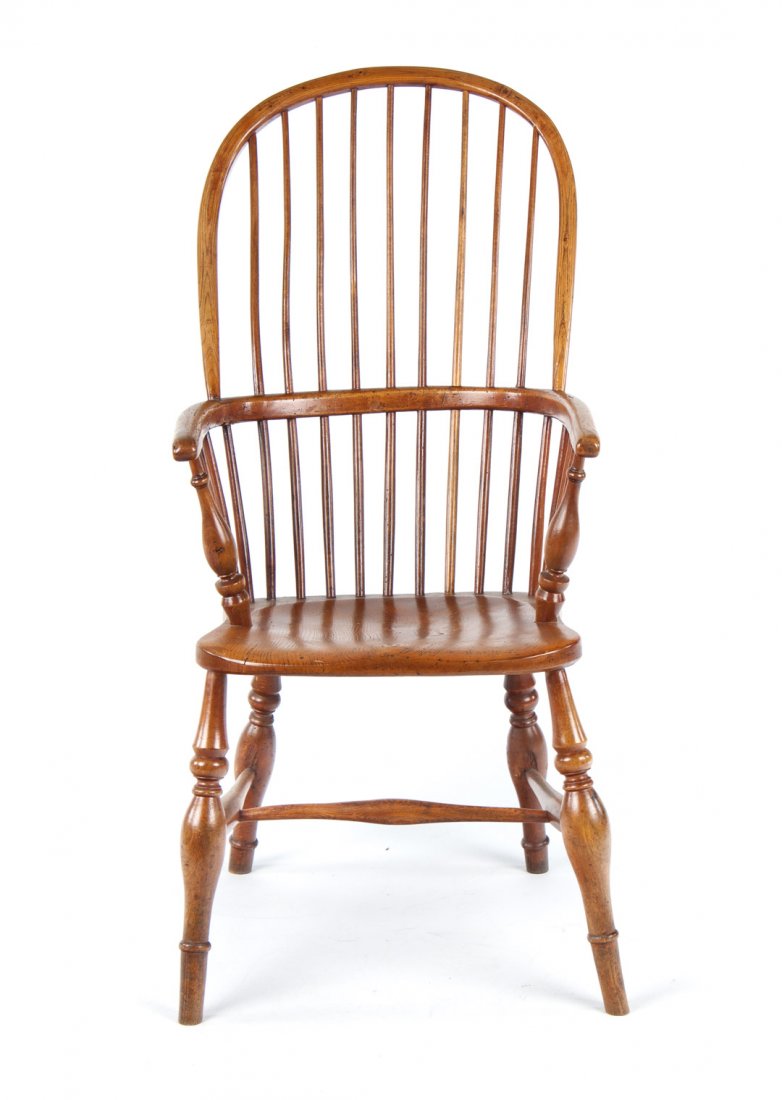 Victorian elmwood Windsor armchair: mid-19th century; spindled sack back forming curved arms with round-turned arm supports, solid seat, round-turned legs connected by stretchers, 41 in. H., 18 in. W., 18 1/2 in. D.