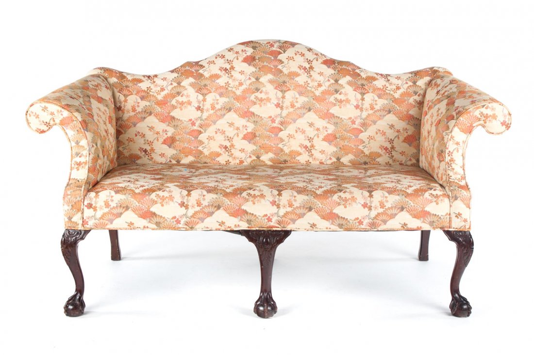 Chippendale style carved mahogany settee: 19th century; serpentine crest rail, back, rolled arms, and seat upholstered over frame, three cabriole front legs with paw and claw feet, 36 1/4 in. H., 58 in. W., 26 in. D.