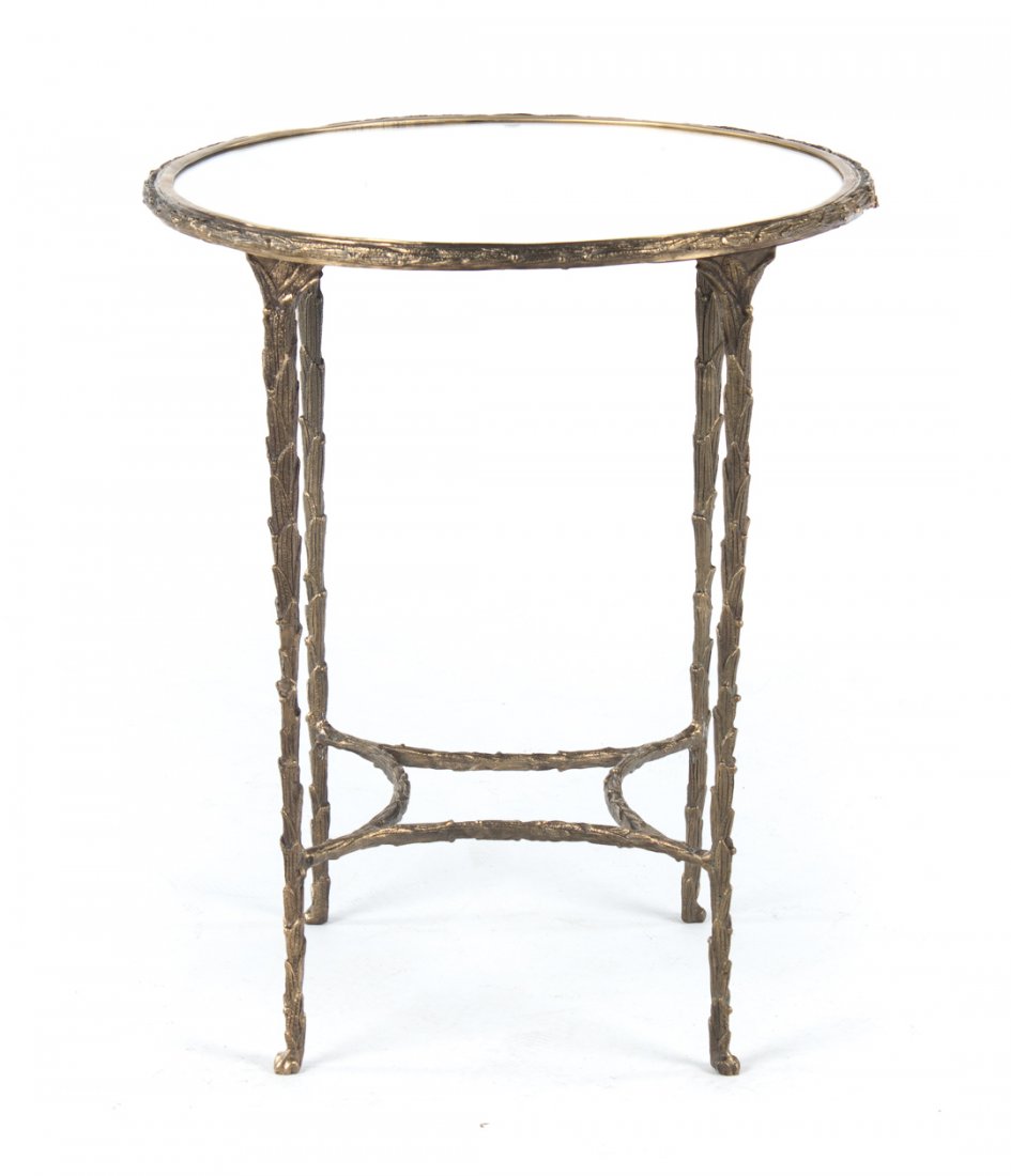 Cast brass mirrored top side table: 20th century; cast foliate decorated legs connected by stretchers, 21 in. round mirrored glass top, 24 1/2 in. H.