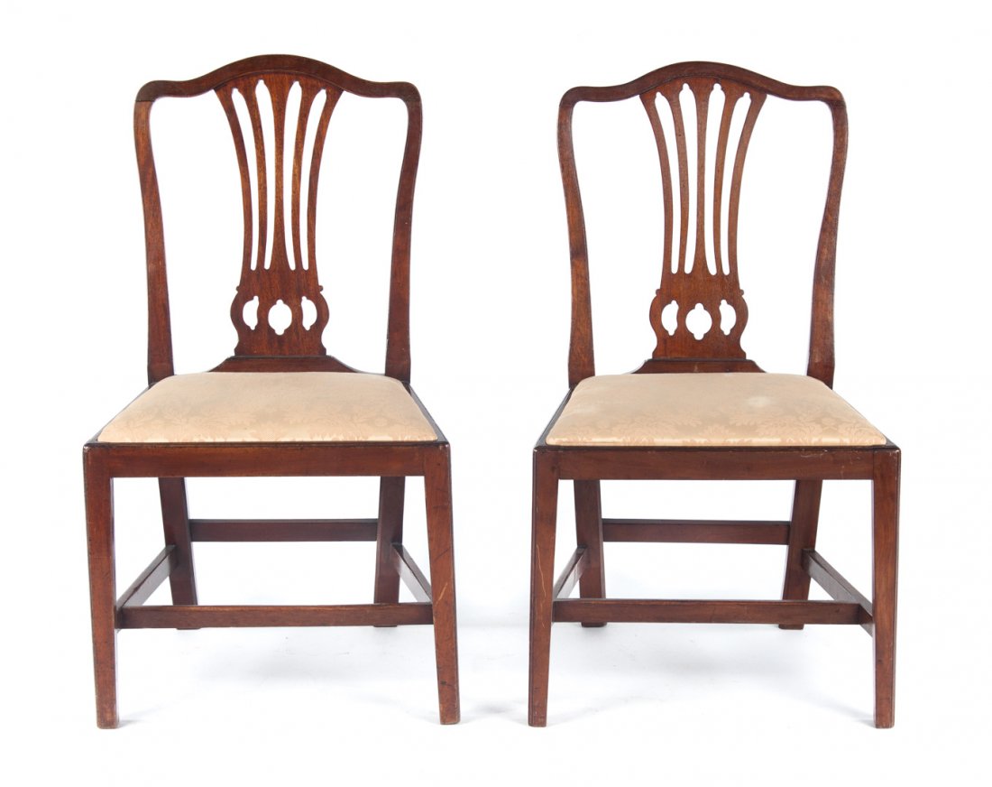 Pair of George III mahogany side chairs: Hepplewhite style, late 18th century; serpentine crest rails, openworked vertical splats, upholstered slip seats, straight legs connected by stretchers, 36 in. H., 21 in. W., 27 in. D.