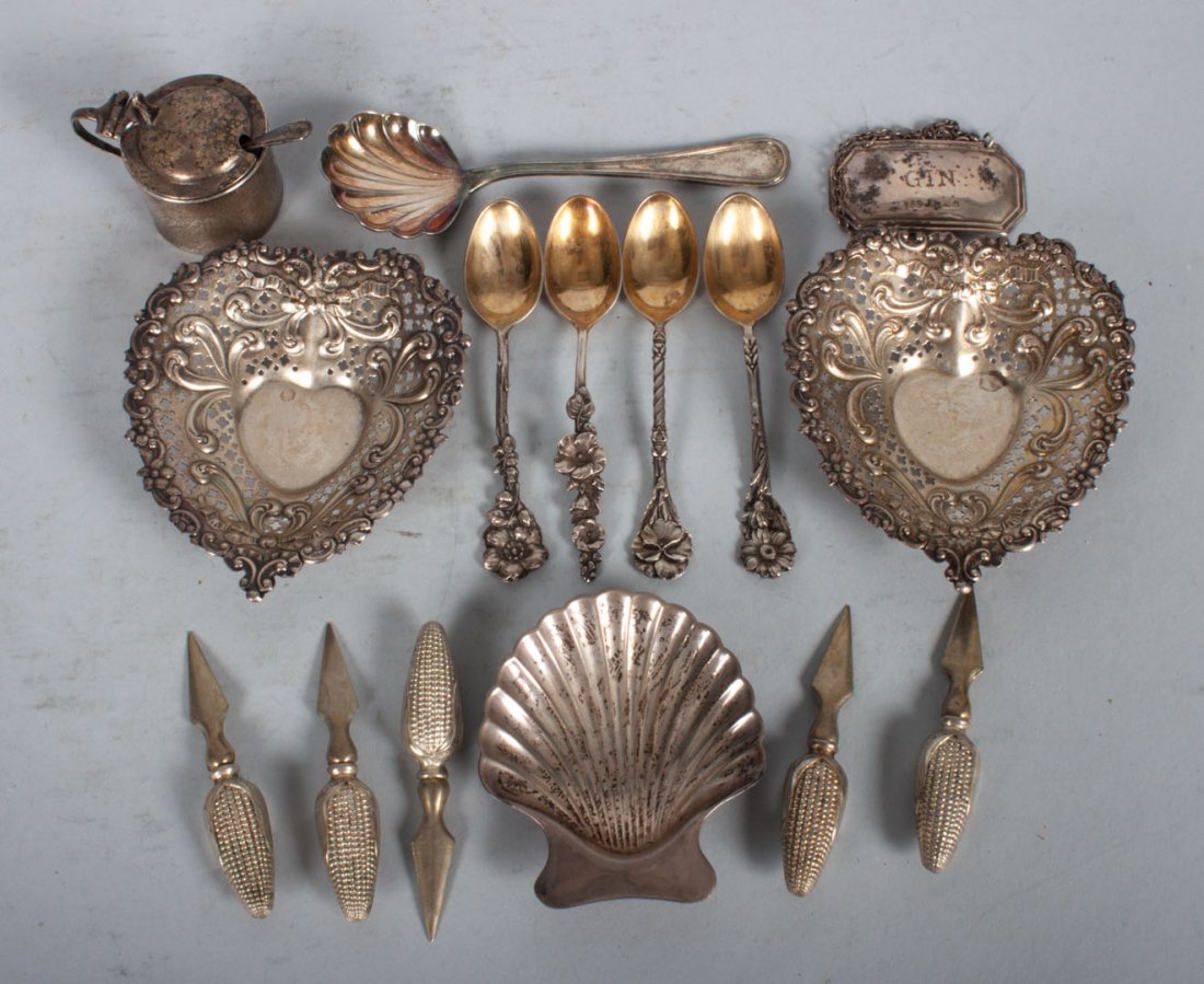 American & continental silver table articles: comprising 16 pieces, including: pair of Gorham heart-shaped pin trays, four floral demitasse spoons, Tiffany shell-form dish, English "Gin" label, English mustard pot with cobalt liner, English salt 