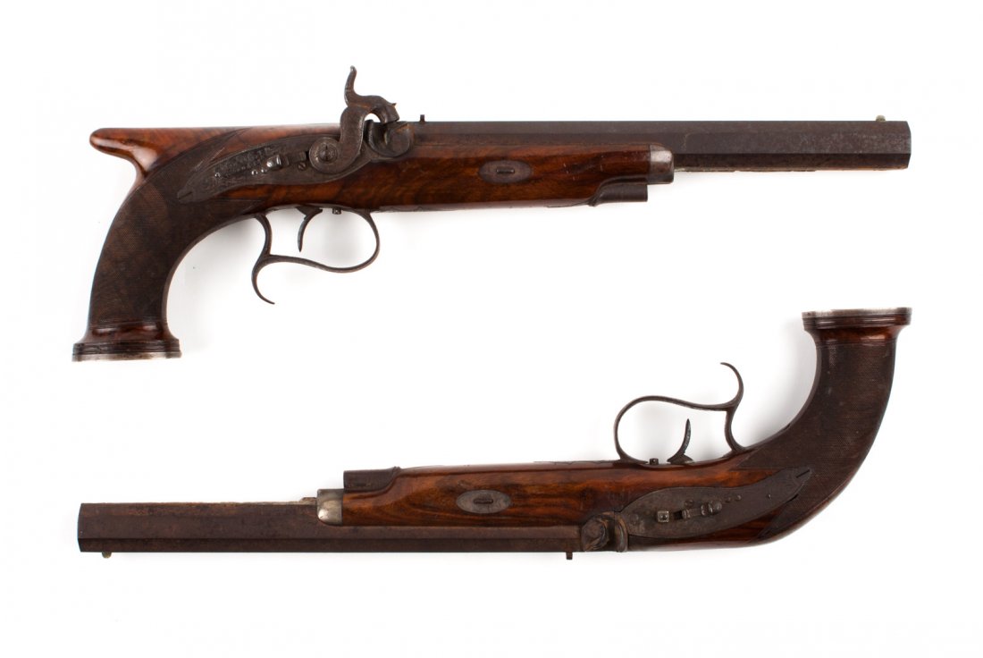 Cased pair of English duelling or target pistols: Van Wart, Son, & Co., London, first half-19th century; .15 mm caliber, percussion mechanism with safety catch; octagonal barrel, 10 in. L.; engraved frame; metal parts originally with bright finish; c