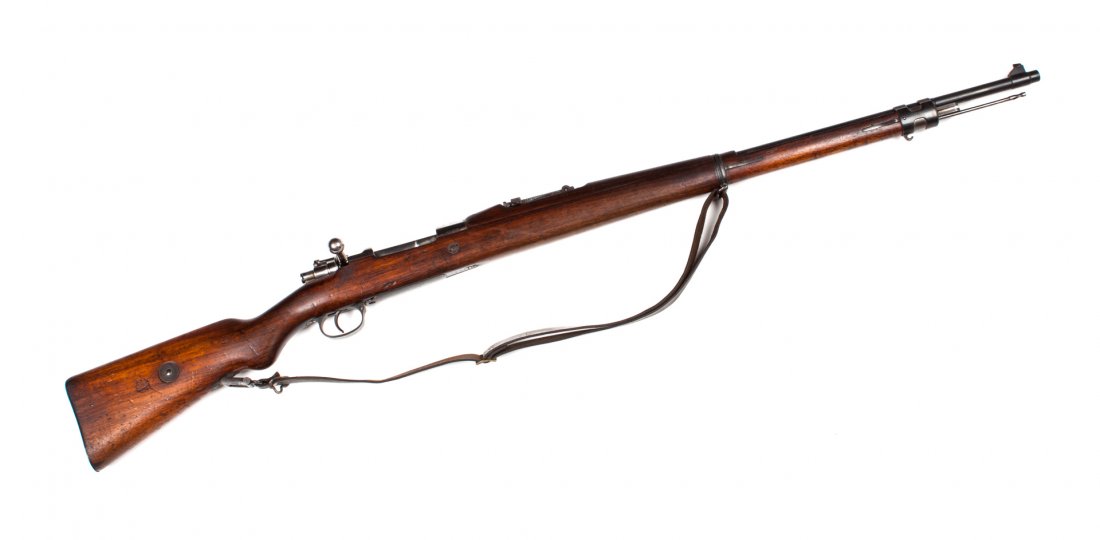 German WM Mauser Model 1908, Brazilian service r: bolt-action rifle, serial #1502, early 20th century: the barrel 30 in. L.; receiver and frame with bright finish, the balanca blued; walnugt stoock and hand guard; 49 in. L. overall; old leather sling