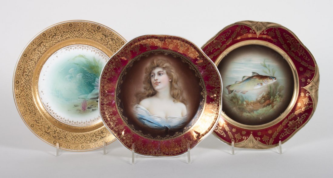 Three Austrian and English cabinet plates: first quarter-20th century; two Austrian painted porcelain cabinet plates, one with portrait of young beauty, the other a fish, 9 in. Diam.; Minton china jellyfish and coral painted plate with gilt bo
