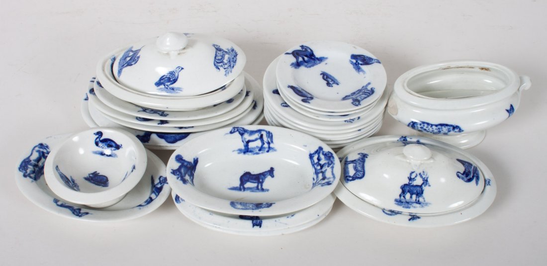 Copeland-Spode child's 23-piece china set: circa 1905; miniature blue transfer decorated partial dinner service in the "Animals" pattern, 23 pieces, including: platters, covered serving dishes, plates, bowls, etc.