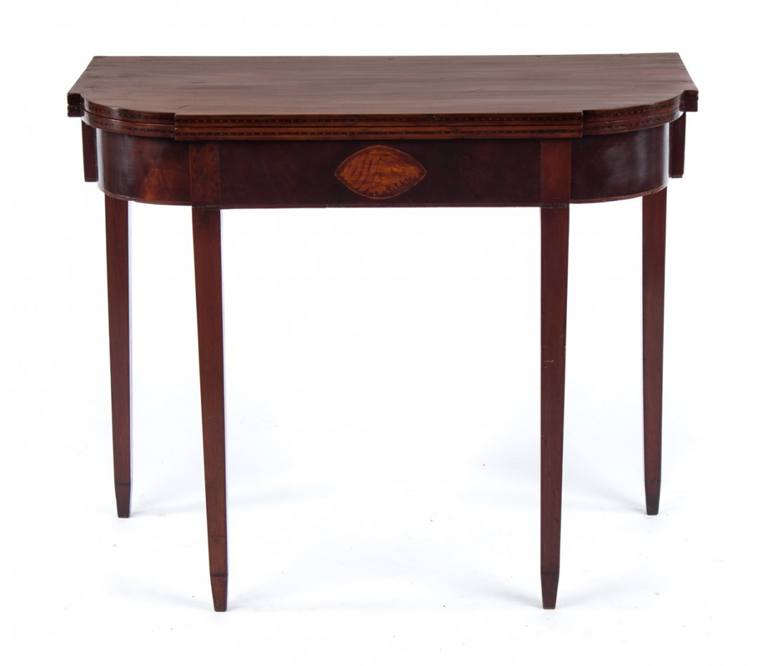 Federal inlaid mahogany flip-top games table: Salem, Massachusetts, circa 1810; flat top with ovolo corners and inlaid edge, shell inlay in 4 in. apron, four straight tapered legs with double tapered feet, 30 in. H., 35 1/2 in. W., 17 1/2 in. D.