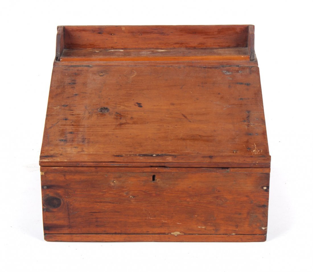 American vernacular pine clerk's desk: first quarter-19th century; writing surface lifts to reveal storage area, 16 in. H., 23 in. W., 21 in. D.