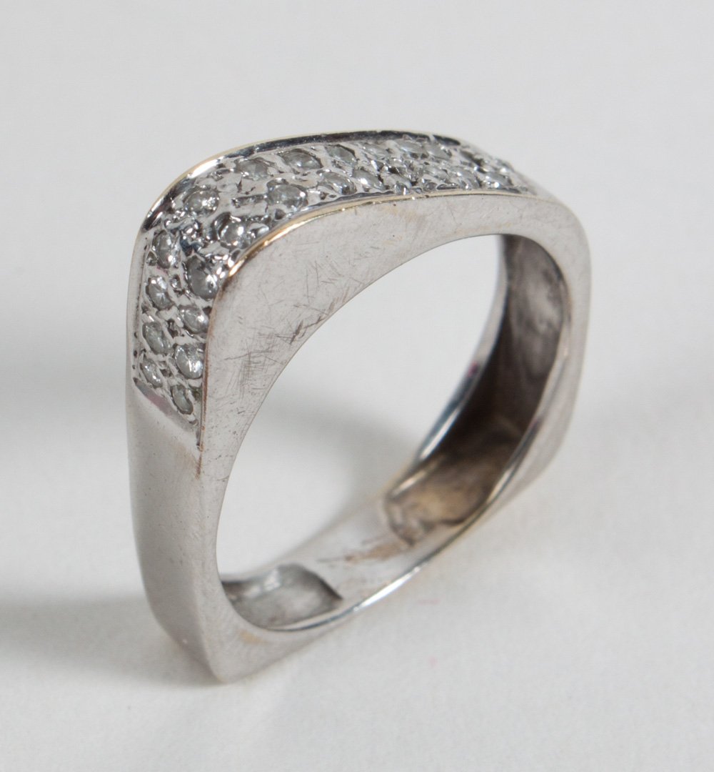 Lady's white gold and diamond ring: circa 1960's, modern design attributed to Mark Nusinov, unmarked white gold, tests as 14K, size 5 3/4, 4 grams