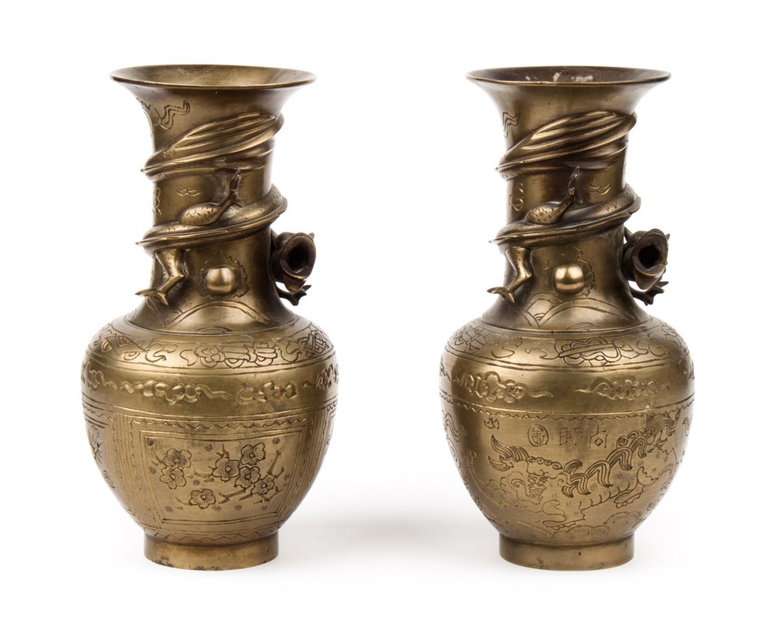 Pair of Chinese brass vases: late 19th/early 20th century; with etched floral, calligraphy, and dragon relief decoration, 9 in. H.