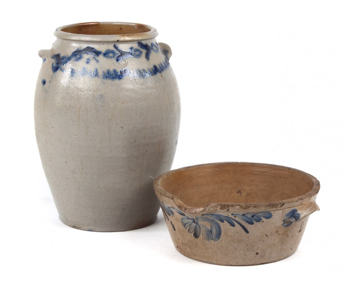Two American stoneware crocks: second half-19th century; both foliate cobalt decorated salt-glazed stoneware; double-handled ovoid storage crock, 14 in. H.; double-handled batter crock with molded spout, 4 1/2 in. H., 11 1/2 in. Di