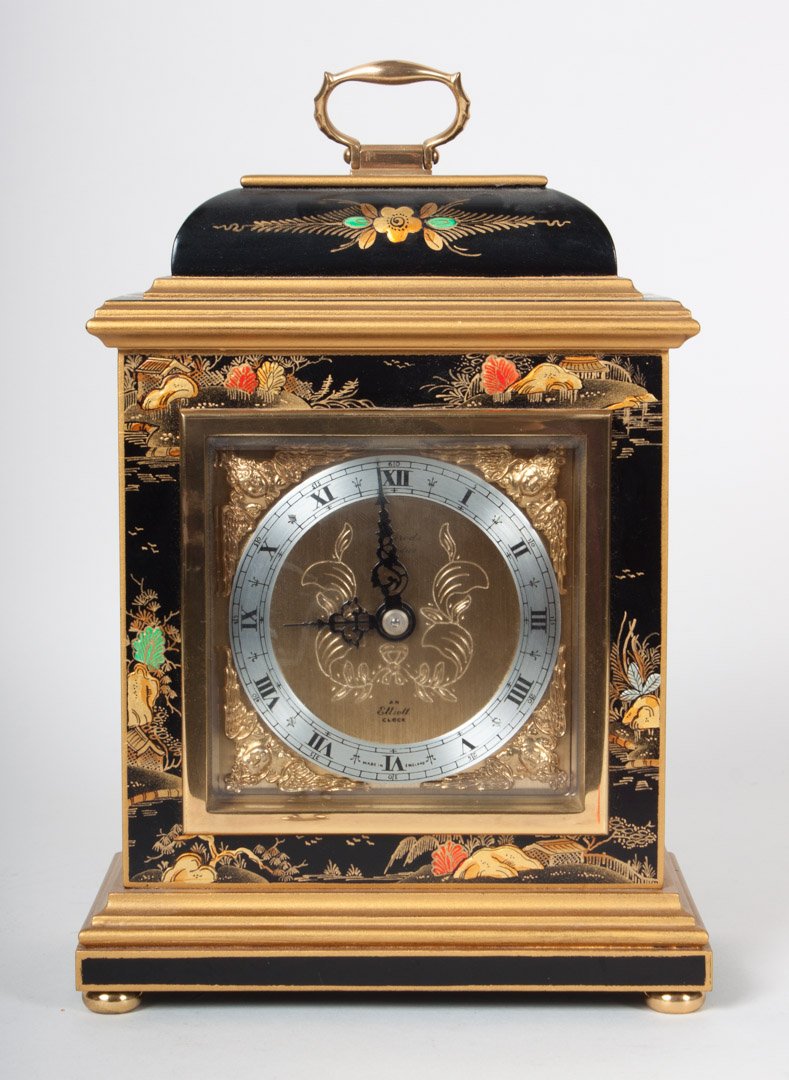 Elliot Georgian style japanned bracket clock: elaborate japanned wood case with etched brass and silvered metal face, 8 in. H.