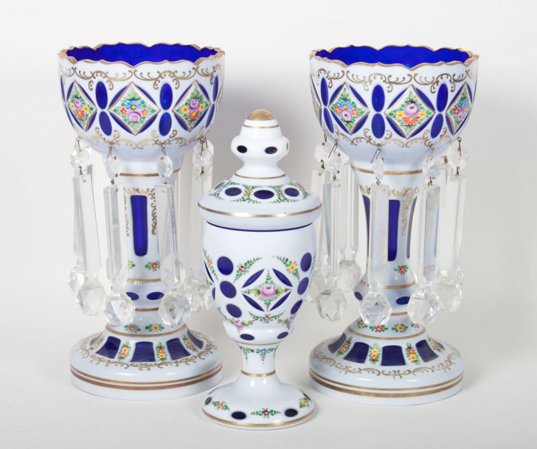 Pair of Bohemian cased glass lustres & vase: fourth quarter-19th century; calcite cut-to-cobalt with parcel-gilt and floral enamel, cut glass prisms, together with a similar covered cup, 12 1/2 and 10 in. H.