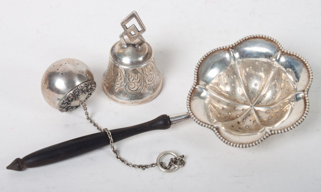 Tiffany & Co. sterling silver tea ball & chain: together with a small engraved sterling bell and a sterling tea strainer with ebony handle; 2.05 ozt. of weighable silver